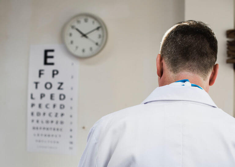 optometrist with eye chart