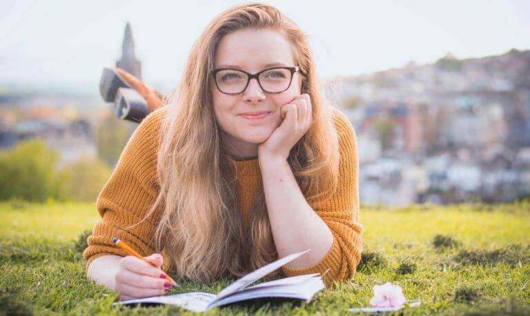 young woman wearing glasses and smiling