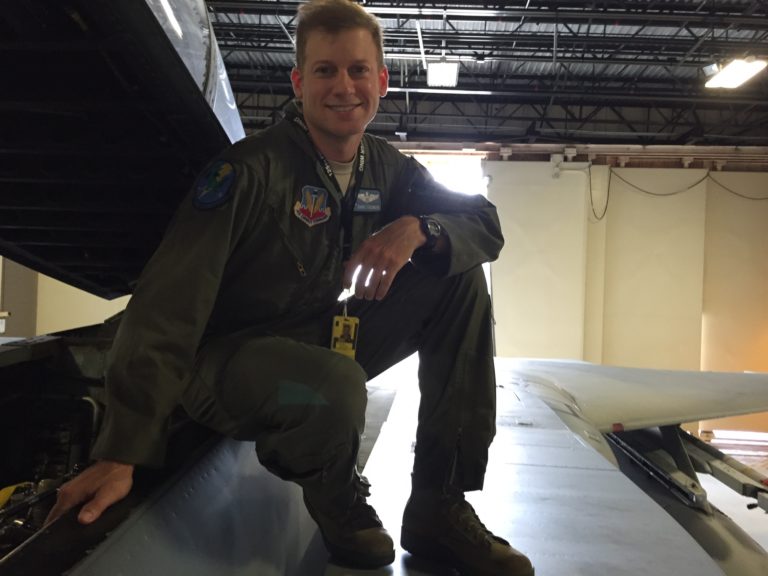 David S., a pilot, sitting on top of a plane