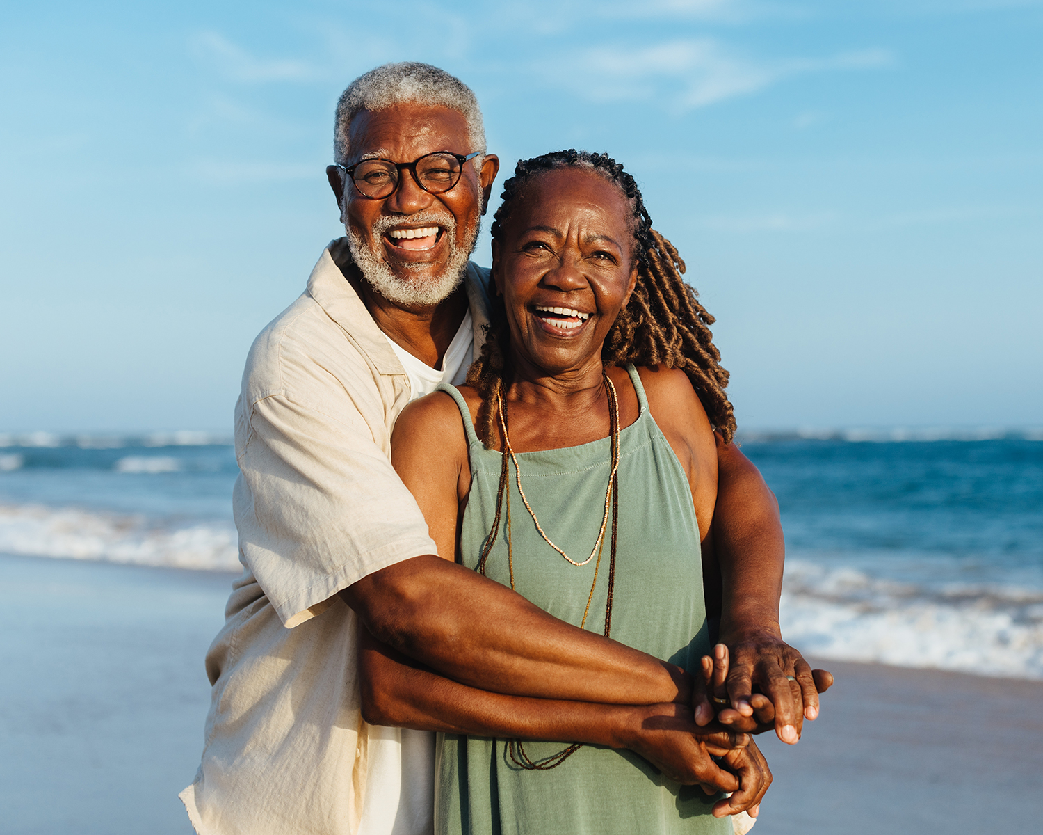 happy couple embracing by the ocean